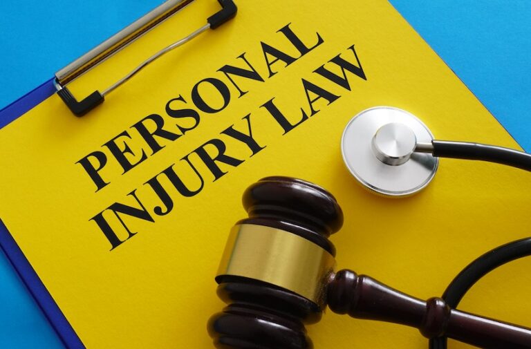 A personal injury law document with a medical stethoscope and a legal gavel represents the injury claims process in Georgia/Tennessee at Ross Moore Law.