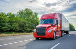 Red commercial semi-truck hauling freight representing Atlanta commercial vehicle transportation on an open highway.