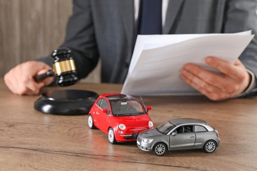 Decatur Uber accident lawyer with toy cars and a gavel