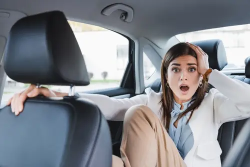 Shocked rideshare passenger in Johns Creek after an Uber or Lyft accident, represented by Ross Moore Law a skilled Johns Creek rideshare accident lawyer.
