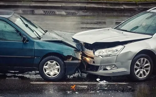 Marietta drunk driving accident scene with two cars crashed on a rainy road.
